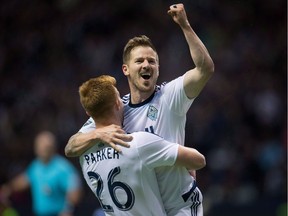 Veteran left-back Jordan Harvey, being hoisted up Tim Parker during an MLS game earlier this season at B.C. Place Stadium, has been a Whitecap since 2011. He won the player of the year honours in a landslide fan vote with 48 per cent support.