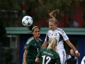 Trinity Western's Brooklyn Tidder (centre) heads home the opening goal of the match Friday in Langley as the host Spartans went on to edge Gurneet Dhaliwal, Karlee Pedersen, and the rest of Abbotsford's Fraser Valley Cascades 3-2 in a battle of the nationally-ranked sides.