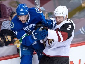 Arizona Coyotes' Luke Schenn, right, checks Vancouver Canucks' Troy Stecher during the third period of a pre-season NHL hockey game in Vancouver, B.C., on Monday October 3, 2016.