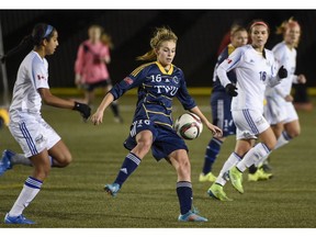 VANCOUVER, BC: November 15, 2015 --  UBC Thunderbirds surround TWU Spartans Jenaya Robertson, centre during the Gold medal match of the 2015 Women's Soccer Championship at Thunderbird Stadium in Vancouver , B.C. Sunday November 15, 2015.