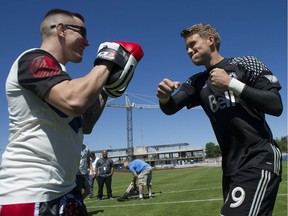 Vancouver Whitecaps FC2 goalie Spencer Richey, right, gets some punching tips last July. He's the starter for the USL team in the Western Conference final Kansas City on Saturday.