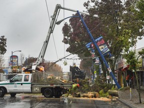 Crews work on Oct. 14 to clear trees on Kingsway near Tyne in Vancouver brought down by high winds that also cut power to 195,000 B.C. Hydro customers in the Lower Mainland and on Vancouver Island. Arlen Redekop/PNG files