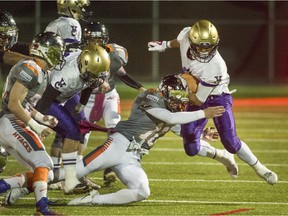 New Westminster Hyacks' Sammy Sidhu makes a tackle on Vancouver College running back Michael Le on Friday at Mercer Stadium.