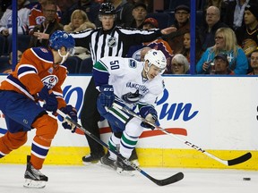 Griffin Reinhart of the Edmonton Oilers tries to track down Brendan Gaunce of the Vancouver Canucks. Gaunce's second season has been the polar opposite of the first so far, because the Canucks are doing one big thing differently: they're winning.