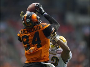 Lions receiver Emmanuel Arceneaux hauls in a pass for a touchdown while pressured by Edmonton's Tyler Thornton at B.C. Place.