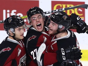 Darian Skeoch, right, celebrates a goal with Vancouver Giants teammates Brendan Semchuk, centre, and Dawson Holt last week.