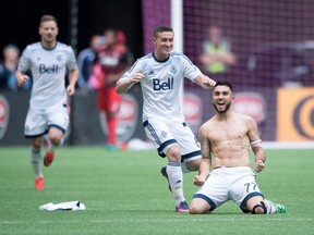 Vancouver Whitecaps' Pedro Morales, right, and Fraser Aird celebrate Morales' goal against the Portland Timbers during the second half of an MLS soccer game in Vancouver, B.C., on Sunday October 23, 2016.