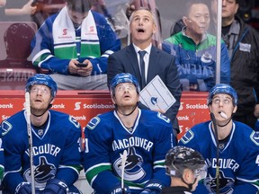 Vancouver Canucks' head coach Willie Desjardins, top, stands on the bench behind Vancouver Canucks' Jannik Hansen, left, Jack Skille and Mike Zalewski during the second period of Saturday's against the Washington Capitals. With a tough stretch coming up on the road for the team, the Willie Watch will be in full effect.