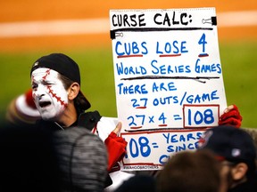 CLEVELAND, OH - OCTOBER 26:  A fan holds a sign during Game Two of the 2016 World Series between the Chicago Cubs and the Cleveland Indians at Progressive Field on October 26, 2016 in Cleveland, Ohio.