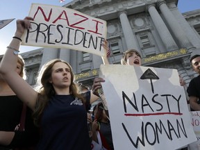 Mission High School students Hope Robertson, left, and Cat Larson yell as they protest with other high school students in opposition of Donald Trump's presidential election victory in front of City Hall in San Francisco, Thursday, Nov. 10, 2016. (AP Photo/Jeff Chiu) ORG XMIT: CAJC116