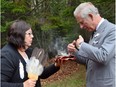 ePrince Charles takes part in a smudging ceremony with Chief Matilda Ramjattan in Bonshaw Provincial Park, P.E.I. on Tuesday, May 20, 2014. THE CANADIAN PRESS/Paul Chiasson ORG XMIT: pch502