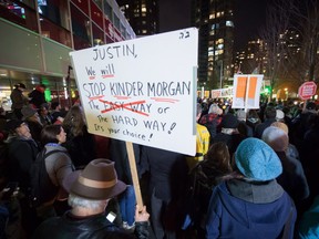 People listen during a protest against the Kinder Morgan Trans Mountain Pipeline expansion project, in Vancouver, B.C., on Tuesday November 29, 2016. Prime Minister Justin Trudeau approved the $6.8-billion project that will nearly triple the capacity of the pipeline that carries crude oil from near Edmonton to the Vancouver area to be loaded on tankers and shipped overseas. THE CANADIAN PRESS/Darryl Dyck ORG XMIT: VCRD110