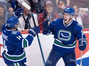 Vancouver Canucks' Bo Horvat, right, celebrates his goal against the Chicago Blackhawks with teammate Alex Burrows during the second period of an NHL hockey game in Vancouver, B.C., on Saturday November 19, 2016.