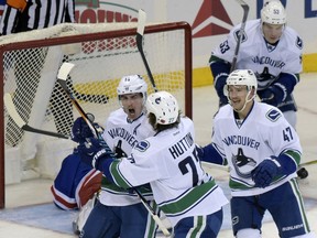 Vancouver Canucks winger Alex Burrows (front left) celebrates his goal with Ben Hutton while linemate and Sven Baertschi gets set to join the party and their centre, Bo Horvat, brings up the rear during the NHL game the trio were first put together as a unit, against the New York Rangers at Madison Square Garden on Nov. 8.