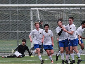 St. Michaels University School Blue Jags players celebrate winning goal in their 2-1 win over Bodwell Nov. 23 in Burnaby for the B.C. double-A championship title.