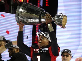 An Ottawa Redblacks fans holds up a "defence" sign before the Grey Cup game Sunday in Toronto.