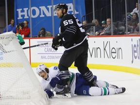 Loui Eriksson is checked by Johnny Boychuk.