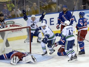 The Canucks' Alex Burrows (14) celebrates one of his two goal.