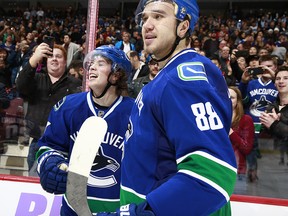 Ben Hutton is congratulated by teammate Nikita Tryamkin after scoring on an overtime penalty shot.