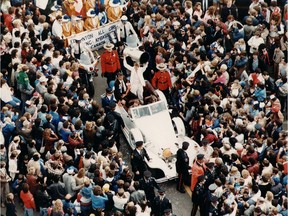 EDMONTON FILE -CROWD parade to pay tribute to the Edmonton Oilers; Wayne Gretzky holds up the Stanley cup at the Victory Parade / 1984 file photo [PNG Merlin Archive]