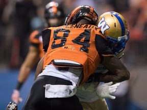 B.C. Lions' Emmanuel Arceneaux is hit by Winnipeg Blue Bombers' Taylor Loffler during the second half of Sunday's game. Arceneaux was knocked and Loffner was penalized, giving the Lions a first down.