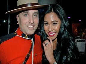 Surrey RCMP Sgt. Paul Hayes keeps watch on Suzette Hernandez who modelled $75,000 worth of jewelry raffled off at the Night of a Thousand Stars hospital hootenanny.