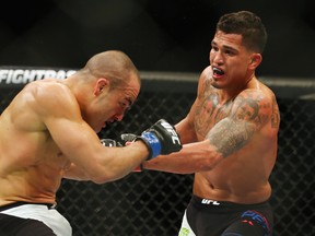 Anthony Pettis, right, punches Eddie Alvarez in their lightweight bout during UFC Fight Night 81 at TD Banknorth Garden on Jan. 17, 2016 in Boston.