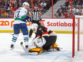 Senators goalie Mike Condon of the makes a save against Daniel Sedin on Thursday in Ottawa.
