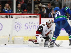 Ben Hutton of the Vancouver Canucks scores on Louis Domingue of the Arizona Coyotes on an overtime penalty shot during their NHL game at Rogers Arena Thursday night.