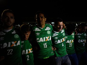 Brazil's Chapecoense club's employees and footballers take part in a Wednesday night tribute to their fellow players killed in a plane crash Monday night in Colombia, at the club's stadium in Chapeco