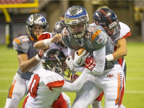 New Westminster Hyacks' Shane Belsher finds himself surrounded by Abbotsford tacklers during Subway Bowl quarterfinal action Saturday at B.C. Place Stadium. (Francis Georgian, PNG photo)
