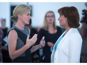 B.C. Hydro CEO Jessica McDonald, left, speaks to British Columbia Premier Christy Clark after she announced the province's climate action plan at the still under construction Carbon Capture and Conversion Institute, in Richmond on Friday August 19, 2016.
