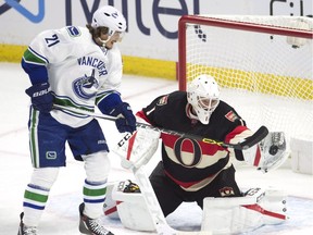 Vancouver Canucks left wing Loui Eriksson (21) pressures Ottawa Senators goalie Mike Condon (1) as he tries to make a save during third period NHL action in Ottawa on Thursday, November 3, 2016.