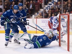 The Rangers' Mika Zibanejad, right, is stopped by Canucks goalie Jacob Markstrom.