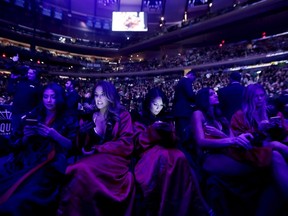 Octagon-side models look at their cell phones between mixed martial arts bouts at UFC 205 last week at Madison Square Garden in New York. The packed house was indicative of what an exciting card can elicit in terms of attendance and hype.