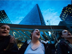 Women shout during a rally against U.S. President-elect Donald Trump outside the still under construction Trump Hotel, in Vancouver, B.C., on Thursday November 10, 2016.