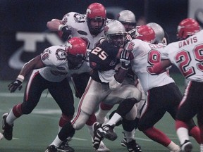 B.C.'s Sean Millington is swarmed by the Calgary Stampeders during a regular-season game at B.C. Place in 2000. The Lions, who finished 8-10 that season, beat the Stamps in the West Final that year.