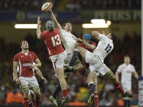 England's no 8 Tom Wood (C) reaches for the ball during the Six Nations international rugby union match between Wales and England at the Millennium Stadium in Cardiff in 2013. Wales won 30 - 3.