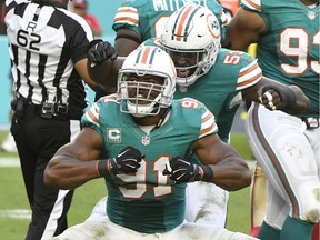 The Dolphins' Cam Wake, front, celebrates his sack last Sunday against San Francisco 49ers. The former B.C. LIon has been a big part of Miami's six-game winning streak.