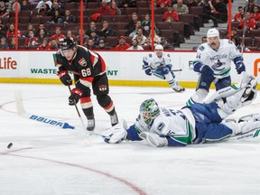 Mike Hoffman skates towards the puck as Jacob Markstrom comes out of his net. Hoffman scored seconds later.