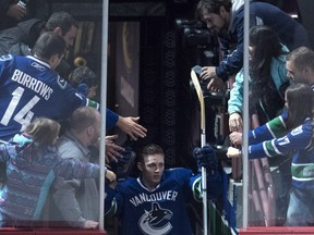Vancouver Canucks defenceman Troy Stecher (51) greets fans as he is given the third star for the night after scoring his first NHL goal during NHL action against the Dallas Stars