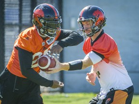A former star quarterback himself, Travis Lulay, right, never complained about his limited but effective role with the B.C. Lions this year.