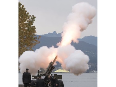 The Lions are seen in the background along the North Shore Mountains as a cannon is fired off during the 21 gun salute during Remembrance Day celebrations in Vancouver, B.C., on Friday, Nov. 11, 2016.