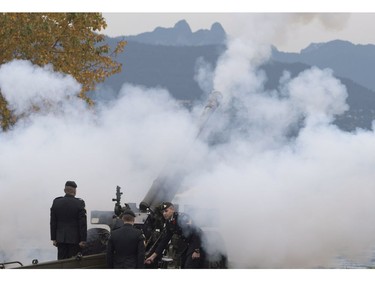 The Lions are seen in the background along the North Shore Mountains as a cannon is fired off during the 21 gun salute during Remembrance Day celebrations in Vancouver, B.C., on Friday, Nov. 11, 2016.
