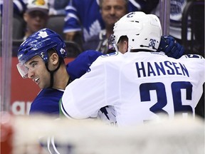 Vancouver Canucks right-winger Jannik Hansen takes on Nazem Kadri after the Maple Leafs centre decked Daniel Sedin with a blindside hit Saturday action in Toronto.