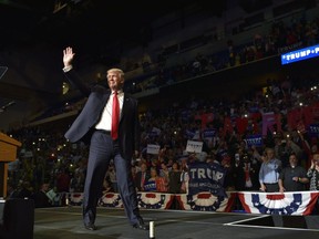 (FILES) This file photo taken on October 10, 2016 shows Republican presidential nominee Donald Trump arriving on stage during a rally at Mohegan Sun Arena in Wilkes-Barre, Pennsylvania. Donald Trump said on November 9, 2016 he would bind the nation's deep wounds and be a president "for all Americans," as he praised his defeated rival Hillary Clinton for her years of public service.