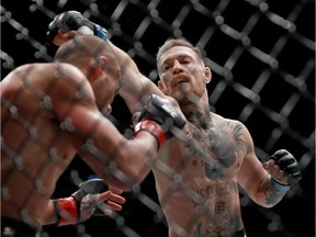 Conor McGregor of Ireland punches Eddie Alvarez in their UFC lightweight championship fight during the UFC 205 event at Madison Square Garden on Saturday in New York.