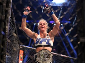 MELBOURNE, AUSTRALIA - NOVEMBER 15:  Holly Holm of the United States celebrates victory over Ronda Rousey of the United States in their UFC women's bantamweight championship bout during the UFC 193 event at Etihad Stadium on November 15, 2015 in Melbourne, Australia.  (Photo by Quinn Rooney/Getty Images)