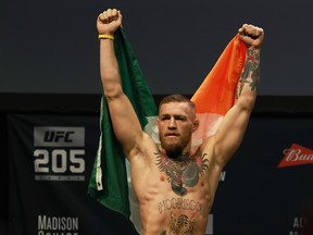 UFC Featherweight Champion Conor McGregor reacts as he walks on stage for UFC 205 Weigh-ins at Madison Square Garden on November 11, 2016 in New York City.