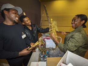Alliance Babunga and brothers Durque (left) and Moses (centre) help decorate the Surrey Christmas Bureau's toy depot to get ready for the season. It is one of the agencies supported by The Province's Empty Stocking Fund.